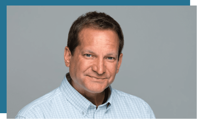 A man with short hair and a blue shirt.